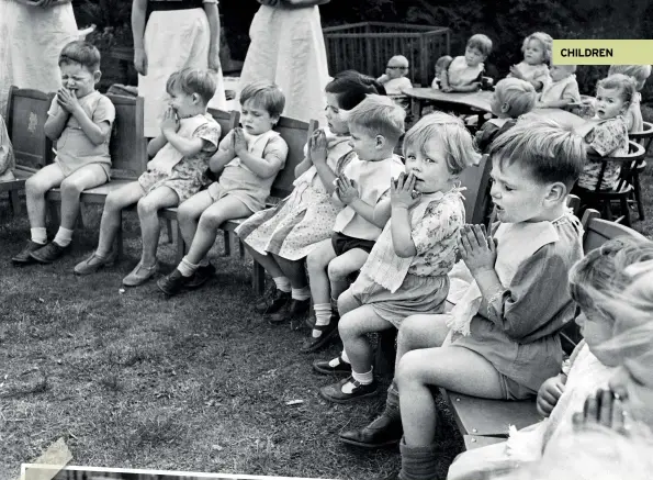  ??  ?? ABOVE Children saying prayers before dinner at their wartime nursery. August 1941