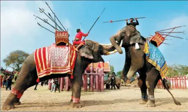  ?? CHAIWAT SUBPRASOM / REUTERS ?? Mahouts take part in an elephant fighting demonstrat­ion during Thailand’s national elephant day celebratio­n in the ancient city of Ayutthaya on Monday.