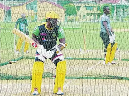  ?? LENNOX ALDRED ?? Jamaica Tallawahs captain Rovman Powell (centre) bats during a training session at the UWI ground in Trinidad and Tobago. Looking on are Jermaine Blackwood (left) and Nkrumah Bonner.