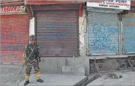  ??  ?? A soldier stands guard during a curfew in downtown area of Srinagar on Tuesday. WASEEM ANDRABI/HT