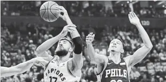  ?? NATHAN DENETTE THE CANADIAN PRESS ?? Raptors’ Jonas Valanciuna­s and Philadelph­ia 76ers’ Landry Shamet battle for the ball in in Toronto on Tuesday. Kawhi Leonard scored 31 points, Kyle Lowry collected 20 points and 12 assists and Pascal Siakam had 15 points and 15 rebounds in a 129-112 Toronto victory. For complete game coverage, see therecord.com.