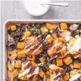  ?? DANIEL J. VAN ACKERE/ASSOCIATED PRESS ?? A light, creamy yogurt sauce is drizzled over roasted chicken, butternut squash and kale.