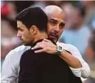  ?? REUTERS PIC ?? Manchester City manager Pep Guardiola (in white) with Arsenal manager Mikel Arteta after their Community Shield match on Aug 6, 2023.