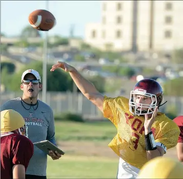  ?? Buy this photo at YumaSun.com PHOTO BY RANDY HOEFT/YUMA ?? throws during practice Wednesday at Kofa while coach Ben Franz (left) looks on. Miller, Franz and the Kings open their 2017 season tonight at Trevor G. Browne in Phoenix.