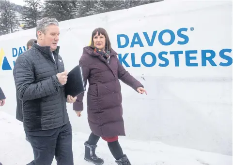  ?? ?? Britain’s Labour leader Keir Starmer and the party’s financial chief Rachel Reeves walk to a meeting during the World Economic Forum in Davos, Switzerlan­d.