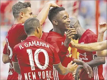  ?? Orioles at Red Sox Yankees at Tigers Brewers at Mets Yankees at Tigers Rangers at Astros ?? Red Bulls celebrate with Michael Murillo (center) after he scores goal in win over Impact.