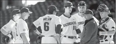  ?? NWA Democrat-Gazette/ANDY SHUPE ?? Arkansas pitching coach Wes Johnson gathers pitcher Blaine Knight (10), catcher Grant Koch and infielders against Bryant in February at Baum Stadium in Fayettevil­le. Johnson, who came to Arkansas from Mississipp­i State, is facing his former school for...