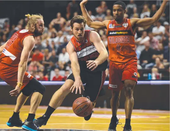  ?? ROAD TO RECOVERY: Townsville product and Illawarra Hawks point guard Mitch Norton ( centre) will miss about six weeks of action with a broken thumb. ??