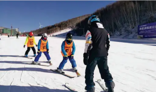  ??  ?? February 2017: A coach instructs children at a ski camp held by Men’s Club in Chongli County, Hebei Province. courtesy of Men’s Club