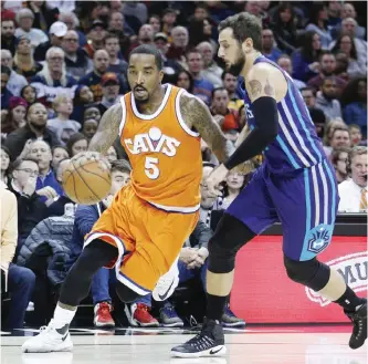  ?? — AP ?? CLEVELAND: Cleveland Cavaliers’ J.R. Smith (5) drives around Charlotte Hornets’ Marco Belinelli (21) during the first half of an NBA basketball game Saturday, in Cleveland.