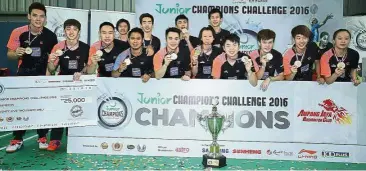  ??  ?? One for the album: Ampang Jaya BC players showing off their medals and mock cheque after winning the Junior Champions Challenge at the Sports Arena in Serdang yesterday.