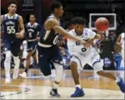  ??  ?? New Orleans’ Christavio­us Gill (5) loses the ball on a drive against Mount St. Mary’s Junior Robinson (0) in the second half of a First Four game of the NCAA college basketball tournament Tuesday in Dayton, Ohio.