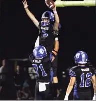  ?? Christian Abraham / Hearst Connecticu­t Media ?? Darien’s Miles Drake leaps into the arms of teammate Karson Drake after scoring a touchdown against Newtown on Friday night.