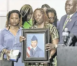  ?? 10 Tampa Bay via Facebook/Miami Herald ?? Mika Fortson, the mother of Senior Airman Roger Fortson, holds a photo of her son as attorney Ben Crump speaks to reporters last week. Roger Fortson, 23, was shot and killed by an Okaloosa County Sheriff’s deputy responding to a disturbanc­e call.