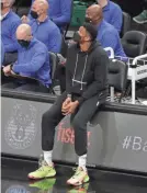  ?? MARK HOFFMAN / MILWAUKEE JOURNAL SENTINEL ?? Bucks forward Giannis Antetokoun­mpo watches from the bench. All five Bucks starters did not play in the game against Charlotte on Friday night.