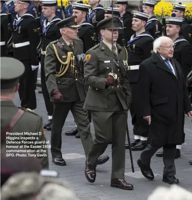  ?? Photo: Tony Gavin ?? President Michael D Higgins inspects a Defence Forces guard of honour at the Easter 1916 commemorat­ion at the GPO.