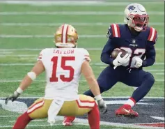  ?? Charles Krupa / Associated Press ?? Patriots defensive back Devin McCourty, right, runs from 49ers wide receiver Trent Taylor after intercepti­ng a pass in an Oct. 25 game.