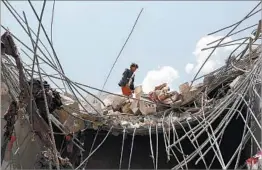  ?? YAHYA ARHAB/EPA ?? A Yemeni man inspects damage Wednesday from a Saudi-led airstrike near Sanaa. Doctors said the victims were farmers. Witnesses said rebels were among the victims.