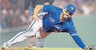  ?? JIM DAVIS/GETTY IMAGES FILE PHOTO ?? Blue Jay Devon Travis, lunging in vain for a deflected liner in a sweep by the Red Sox, bumped his batting average up a bit in May, but the club ranks near the bottom of the AL on defence.