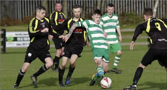  ??  ?? Shane Walker of Arklow Celtic is surrounded by Arklow United trio Karl Kirwan, Jonny Quinn and David O’Neill.