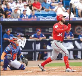  ?? The Associated Press ?? Washington National Bryce Harper watches his home run in front of New York Mets catcher Rene Rivera during a spring training baseball game Saturday in Port St. Lucie, Fla.