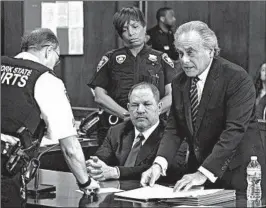  ?? STEVEN HIRSCH/NEW YORK POST ?? Film mogul Harvey Weinstein, seated, listens as his attorney confers with a court officer in New York. The GOP tax law stops victims and companies from deducting legal expenses.