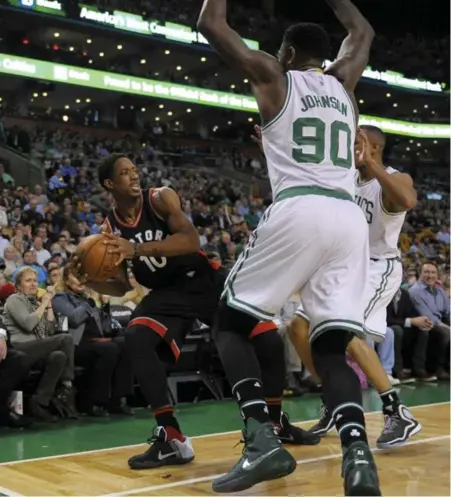  ?? BOB DECHIARA/USA TODAY SPORTS ?? Raptors guard DeMar DeRozan looks for help under pressure from Boston’s Amir Johnson during play Wednesday night in Boston.