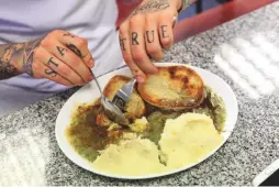  ??  ?? Scaffolder Joe eats lunch at Robins Pie & Mash shop in Southend-On-Sea