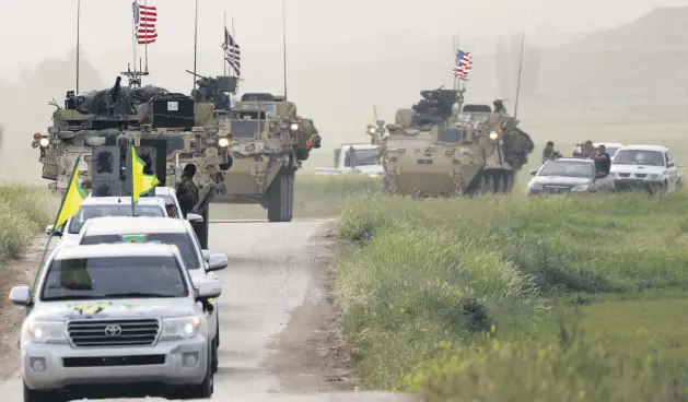  ??  ?? YPG terrorists head a convoy of U.S. military vehicles in the town of al-Darbasiyah next to the Turkish border, April 28, 2017.