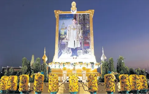 ?? WICHAN CHAROENKIA­TPAKUL ?? ABOVE A large portrait of His Majesty King Bhumibol Adulyadej The Great takes centre stage at an exhibition held to honour the late king’s birthday and Father’s Day at Sanam Luang yesterday.