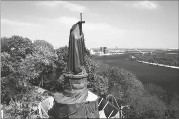  ?? EFREM LUKATSKY/AP ?? A early 200-year old monument to legendary Prince Volodymyr, a Kyiv landmark and one of the symbols of the Ukrainian capital, is wrapped to protect it from Russian shelling in Kyiv, Ukraine on Thursday.