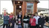  ?? LAURA CATALANO — FOR DIGITAL FIRST MEDIA ?? Winning bidder Karel Minor stands in front of the tiny house with Owen J. Roberts High School STEAM Club members.