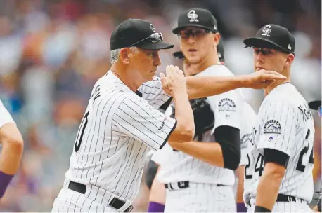  ?? David Zalubowski, The Associated Press ?? Rockies manager Bud Black calls for the left-hander, Phillip Diehl, to replace starter Jeff Hoffman, center, during the sixth inning Wednesday at Coors Field as first baseman Ryan McMahon looks on.
