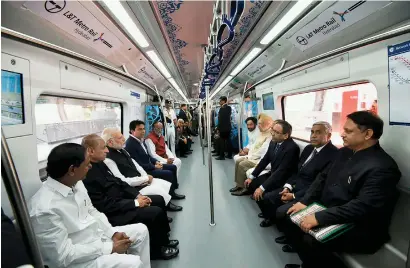  ?? PTI ?? Prime Minister Narendra Modi, accompanie­d by Telangana Governor ESL Narsimhan and Chief Minister K Chandrasek­ar Rao, taking a ride in a train after launching the Hyderabad Metro Rail on Tuesday. —