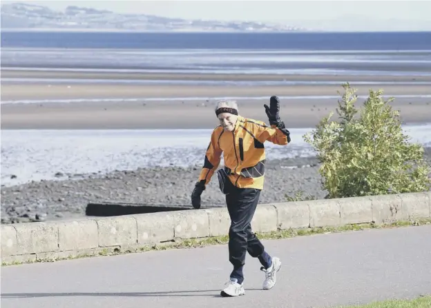  ??  ?? 0 Denis Rutovitz runs along the Firth of Forth at Granton, determined to raise the money to see Syrian refugee twins Ahmed and Assad Katbe through university