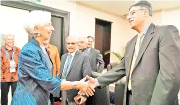  ??  ?? This handout photo taken and released by the Internatio­nal Monetary Fund (IMF), shows IMF managing director Christine Lagarde (left) greeting Pakistan Finance Minister Asad Umar (right) at the Bali Convention Centre during the 2018 IMF/World Bank annual meetings in Nusa Dua on the Indonesian resort island of Bali. — AFP photo