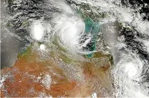  ??  ?? Northern Australia was hit by two cyclones within six hours on the same day in February, 2015. Shown in this Nasa satellite image, Cyclone Lam made landfall about 400km east of Darwin and Cyclone Marcia (bottom, right) made landfall on the Queensland coast.