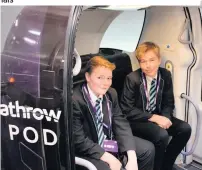  ??  ?? Pupils from Rivers Academy in Hounslow try out a transport pod at Heathrow