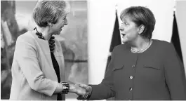  ?? PHOTO: REUTERS ?? Britain's Prime Minister Theresa May ( left) meets German Chancellor Angela Merkel in Berlin on Thursday. Merkel said she would back lowering of EU tariffs on US car imports, responding to an offer from Washington to abandon threatened levies on...