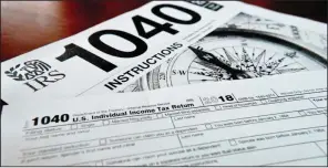  ?? (File Photo/ap/keith Srakocic) ?? Internal Revenue Service tax forms are seen Feb. 13, 2019. Stories circulatin­g online incorrectl­y claim there are no laws requiring people to pay their taxes.