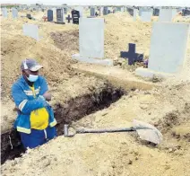  ?? AP ?? A grave digger prepares graves for burial.