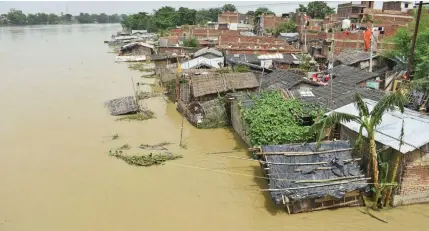  ?? Photo: AFP ?? Flood waters inundate a part of Muzaffarpu­r, in India’s Bihar state, following monsoon rains.