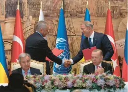  ?? KHALIL HAMRA/AP ?? Russian Defense Minister Sergei Shoigu, left, shakes hands with Turkish Defense Minister Hulusi Akar during a signing ceremony Friday in Istanbul that included U.N. Secretary-General Antonio Guterres, seated left, and Turkish President Recep Tayyip Erdogan.