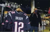  ?? ELISE AMENDOLA — THE ASSOCIATED PRESS ?? Football fan Brian Pope browses for Tom Brady jerseys in the pro shop at Gillette Stadium on Monday in Foxborough, Mass. Tom Brady is going to the Super Bowl for the 10th time and New England Patriots fans are cheering for him — just like before.