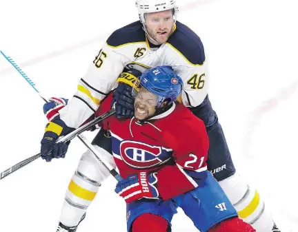  ?? JOHN MAHONEY ?? Canadiens’ Devante Smith-Pelly is checked by Buffalo Sabres’ Cody Franson in Montreal on Wednesday, during the Habs’ 4-2 loss.