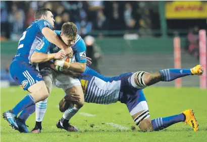  ?? Picture: Gallo Images ?? GOING NOWHERE. Piers Francis of the Blues is tackled by Shaun Treeby and Nizaam Carr of the Stormers during the Super Rugby match at Newlands, Cape Town, last night.