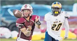  ?? MICHAEL LAUGHLIN/STAFF PHOTOGRAPH­ER ?? Douglas receiver Andrew Siren catches a pass in front of Boca Raton db Torcell Haynes during the first half of their game Friday night.