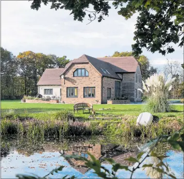  ??  ?? SELF CONTROL: The Hughes family used a Wickhambro­ok design with a barn-style exterior