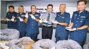  ??  ?? Paddy (third from left), Rozidan (with tie) and Customs officers showing part of the illegal shipment during a press conference at the Customs Complex in KLIA yesterday.