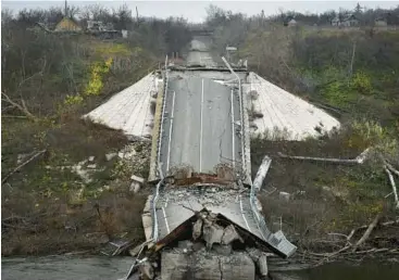  ?? ANDRIY ANDRIYENKO/AP ?? A bridge spanning the Siverskyi Donets River lies in ruins Wednesday in Zakitne, Ukraine.